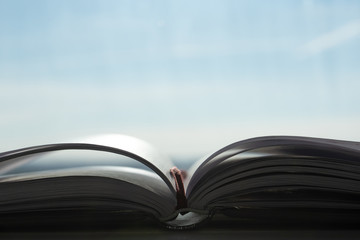 Open notebook for studying on the desk in the morning sun. Front view