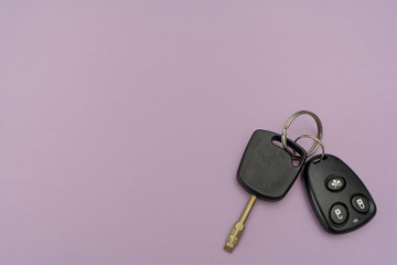 Close-up. Auto key and remote above on the right on purple background. Success in business. Car owner