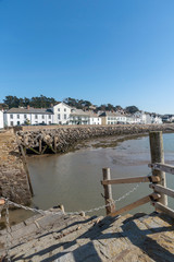 Fototapeta na wymiar Instow, North Devon, England, UK. March 2019. Instow viewed from the harbour steps over the River Kerridge estuary.