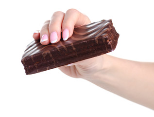 Chocolate cake biscuit in hand on a white background. Isolation