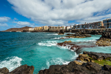 Fototapeta premium Tourism and travel. Windy day on the ocean. Rocky coast. Canary Islands, Gran Canaria, Atlantic Ocean. Tropics. City of Las Palmas