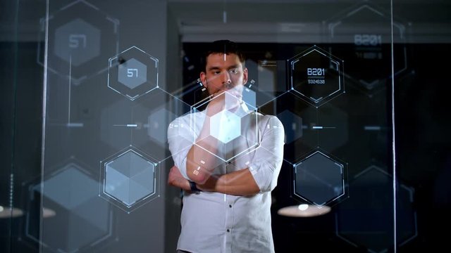 business, future technology and people concept - businessman working and using glass wall at night office