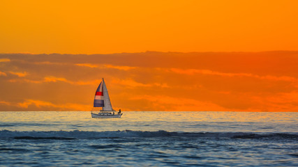 Sunset with sailboat near horizon