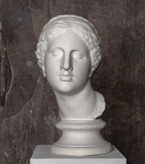 White marble head of young woman. Statue art sculpture of stone face. Ancient beautiful woman monument