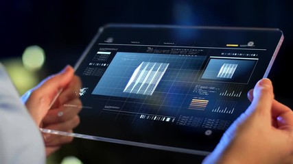 technology, virtual effects and programming concept - hands holding transparent tablet pc computer with numerals counting on screen - Powered by Adobe