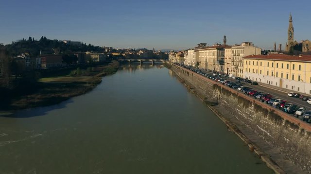 Low altitude aerial view of the Arno river in Florence oa sunny day. Tuscany, Italy