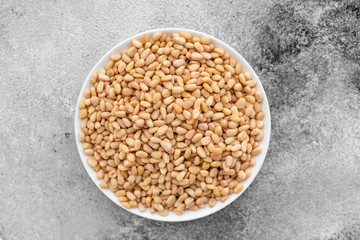 Pine nuts close up. Breakfast, healthy food. It can be used as a background