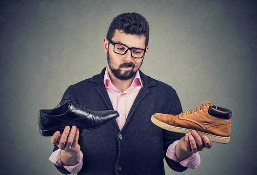 Young man making a shoe choice