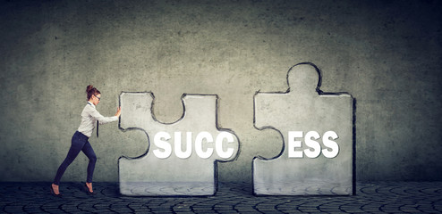 business woman connecting elements of success puzzle