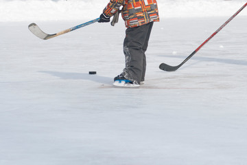 A man with a stick playing ice hockey