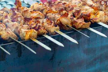 Skewers with meat kebabs on the grill with smoke