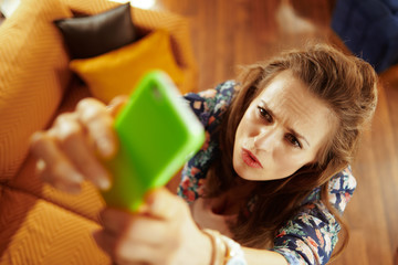 concerned fit woman catching weak wifi signal on smartphone