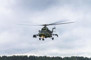 Military helicopter preparing to take off from grassy field © fisher_y