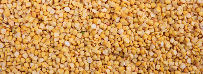 Fototapeta premium Split peas. Yellow orange color split peeled peas uncooked full background, banner