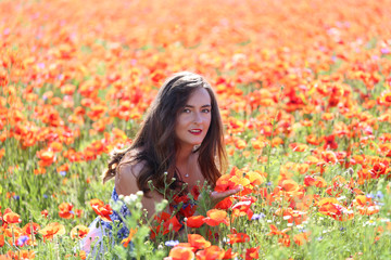 Naklejka premium Portrait of a young girl. The girl in the poppy field.