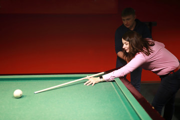 Fototapeta premium Woman playing billiards