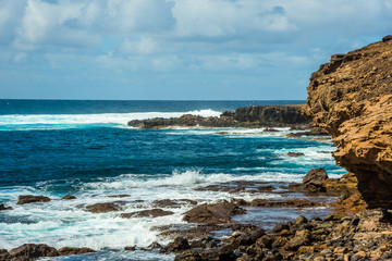 Tourism and travel. Windy day on the ocean. Rocky coast. Canary Islands, Gran Canaria, Atlantic Ocean. Tropics