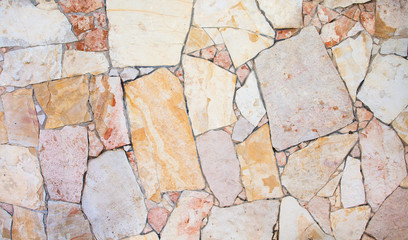 Closeup of neutral beige abstract sandstone mosaic wall. For pattern, texture and background