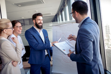 Businessman giving presentation to his colleagues