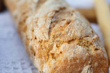 Closeup fresh baked bread on light blurred background
