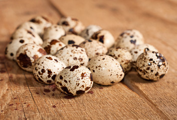 Quail eggs on the wooden background