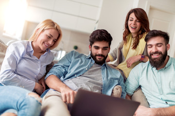 Group of friends watching football game at home