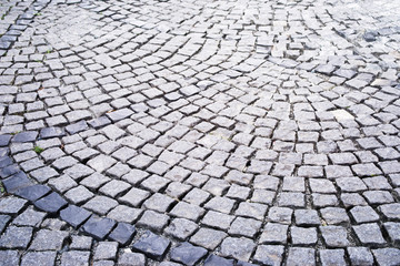 Stone pavement in the old town. Road lined with decorative gray stone, pavement