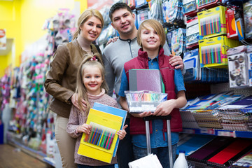 Parents and children buying writing materials