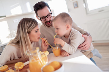 Obraz na płótnie Canvas Family drink fresh orange juice