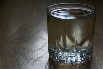 a glass of water on a wooden table