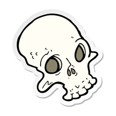sticker of a cartoon spooky skull
