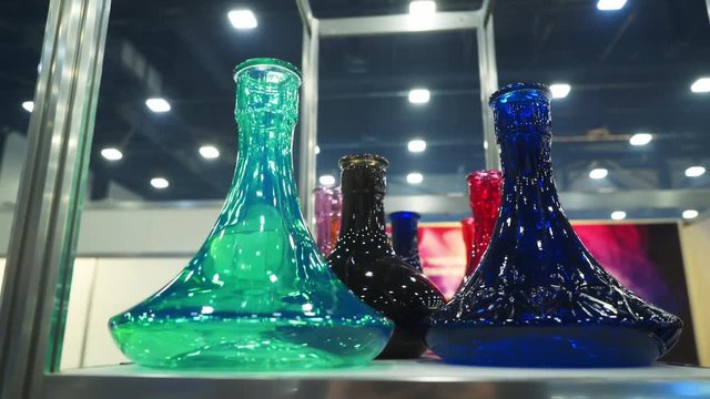 People choosing hookah. Smoking tobacco at exhibition. Shisha bowl at event