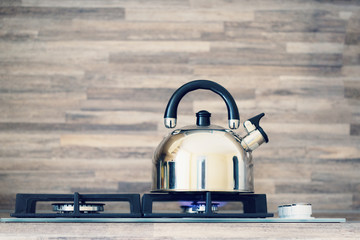 the kettle is heated on a gas stove