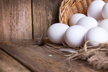 White eggs from the basket on table