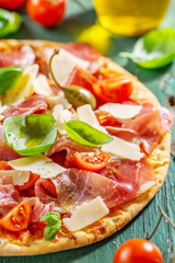 Fototapeta na wymiar Appetizing italian pizza with prosciutto