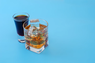 Alcohol in a glass with pastel blue background