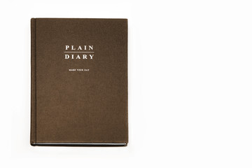 brown daily planner on white background