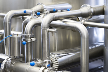 Brewery production concept, industrial background, stainless steel pipe.