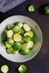 Top view of chopped fresh brussel sprouts on a kitchen table. The concept of healthy vegetarian eating.