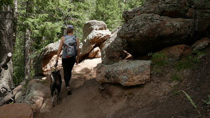 Girl hiking with dog in the forest  © Madeline