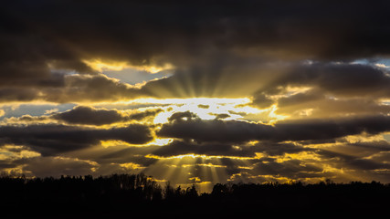 Blue sky and dark clouds with sunlight