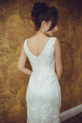 Portrait of a beautiful bride woman in elegant white wedding dress. Luxurious apartments. 