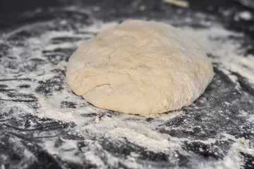 dough on a black table, homemade food