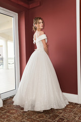 Fototapeta premium Portrait of a beautiful bride woman in elegant white wedding dress. Luxurious apartments. 