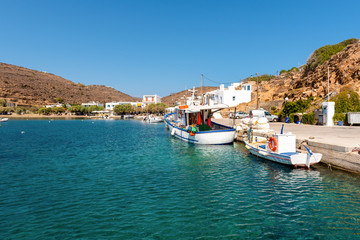 The picturesque seaside village of Faros with fishing boats moored in the port. Sifnos, Greece