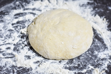 dough on a black table, homemade food