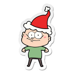 sticker cartoon of a bald man staring wearing santa hat