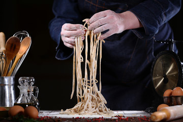 Cook makes homemade pasta in the restaurant. The concept of tasty and healthy food.
