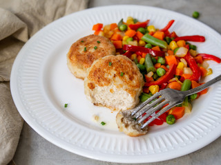 Chicken cutlets with steamed Mix vegetables, Chicken meat balls on white plate. Heathy lunch, diet food. Selective focus, close up.