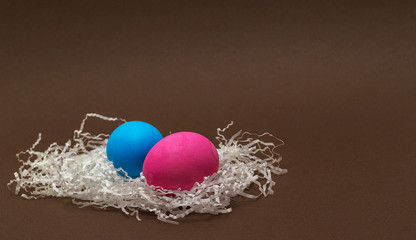 Creative Colorful Easter eggs on chocolate background.